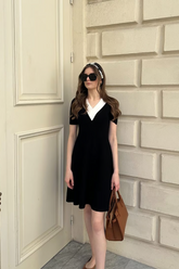 a lady in a black v-neck knitted skirt